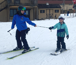 Kid getting ski instruction.
