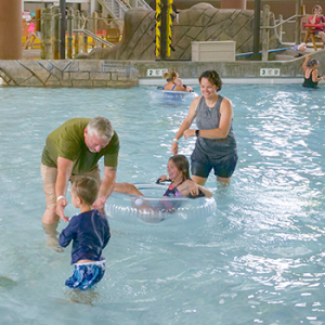 Family playing in the pool.