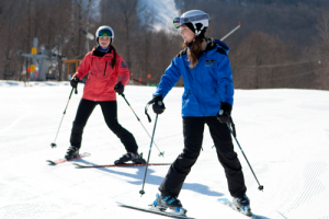 Someone receiving a ski lesson.